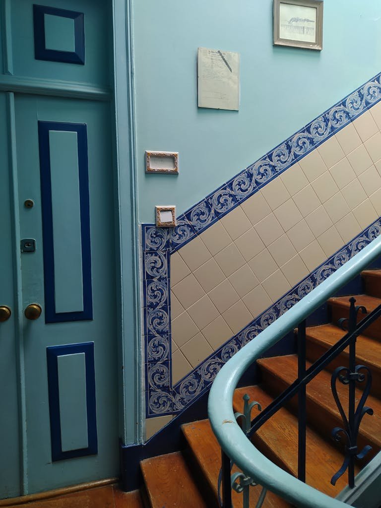 Beautiful interior staircase with traditional blue and white tiles in a Lisbon apartment building.